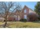 Classic brick residence displaying verdant lawn, manicured shrubbery and traditional architectural design at 7238 River Birch Ln, Indianapolis, IN 46236