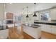 Bright kitchen featuring white cabinets, a center island, and stainless steel appliances at 7238 River Birch Ln, Indianapolis, IN 46236