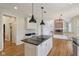 Open-concept kitchen features an island cooktop and a view of the living room at 7238 River Birch Ln, Indianapolis, IN 46236