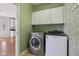 Laundry room with a washer and dryer and white cabinets for storage at 7238 River Birch Ln, Indianapolis, IN 46236