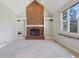 Living room highlighting a cozy fireplace with built-in shelving and a bright window view at 7238 River Birch Ln, Indianapolis, IN 46236