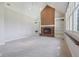 Spacious living room showcasing a brick fireplace with built-in shelving and large windows at 7238 River Birch Ln, Indianapolis, IN 46236