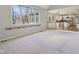Open-concept living room featuring large windows and seamless flow to the bright kitchen area at 7238 River Birch Ln, Indianapolis, IN 46236