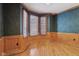 Office featuring wood paneling, hardwood floors, and bay windows at 7238 River Birch Ln, Indianapolis, IN 46236