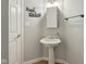 Powder room with a pedestal sink, mirror, and modern lighting at 7238 River Birch Ln, Indianapolis, IN 46236