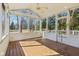 Bright sunroom with wood floors, screened windows, and a ceiling fan at 7238 River Birch Ln, Indianapolis, IN 46236