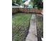 View of the fenced backyard featuring a grass yard and walkway at 749 W 32Nd St, Indianapolis, IN 46208