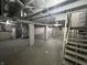 Unfinished basement with exposed ceiling, concrete floor, and support pillars at 749 W 32Nd St, Indianapolis, IN 46208