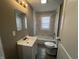 Updated bathroom with a modern vanity, tile surround tub and shower, and neutral color palette at 749 W 32Nd St, Indianapolis, IN 46208