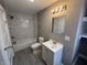 Bathroom featuring a shower-tub combo with stylish tile surround, a modern vanity, and neutral-colored walls at 749 W 32Nd St, Indianapolis, IN 46208