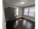 Bedroom featuring dark wood floors, neutral colored walls and built in wardrobe with mirror at 749 W 32Nd St, Indianapolis, IN 46208