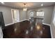Charming dining area featuring hardwood floors, updated lighting, and a view into the adjacent rooms at 749 W 32Nd St, Indianapolis, IN 46208