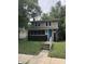 Charming two-story home featuring a blue front door and a brick foundation at 749 W 32Nd St, Indianapolis, IN 46208