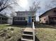 Classic two-story home with a bright blue door, complemented by a brick-and-siding exterior and a cozy screened porch at 749 W 32Nd St, Indianapolis, IN 46208