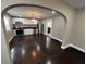 Modern kitchen with stainless steel appliances and white cabinetry, seamlessly connected to the living area through an archway at 749 W 32Nd St, Indianapolis, IN 46208