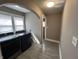 Functional laundry room featuring modern washer and dryer units, neutral tile flooring, and an abundance of natural light at 749 W 32Nd St, Indianapolis, IN 46208