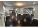 Inviting living room with hardwood floors, a fireplace, and arched openings to the kitchen and staircase at 749 W 32Nd St, Indianapolis, IN 46208