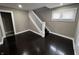 Entry way featuring dark wood floors and white staircase at 749 W 32Nd St, Indianapolis, IN 46208
