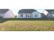 View of the home's rear exterior with a spacious green backyard at 8105 Milender Blvd, Indianapolis, IN 46237
