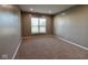 A carpeted bedroom is brightened with a window overlooking the home's exterior at 8105 Milender Blvd, Indianapolis, IN 46237