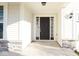 Inviting front entrance featuring stone accents, a contemporary front door and sidelight windows at 8105 Milender Blvd, Indianapolis, IN 46237