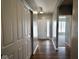 Entry hallway boasting hardwood floors and neutral paint, leading to an open living space at 8105 Milender Blvd, Indianapolis, IN 46237
