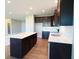 This kitchen features modern appliances, a center island, and dark wood cabinets at 8105 Milender Blvd, Indianapolis, IN 46237