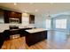 This modern kitchen features an island, white countertops, dark cabinets and stainless steel appliances at 8105 Milender Blvd, Indianapolis, IN 46237
