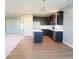 Open kitchen featuring dark wood cabinets, stainless appliances, and island with white counter at 8105 Milender Blvd, Indianapolis, IN 46237