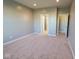 This carpeted bedroom features two open doorways that lead to an ensuite and a walk-in closet at 8105 Milender Blvd, Indianapolis, IN 46237