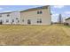 Backyard view of a two-story home with a large grassy area and surrounding residential properties at 8547 S Tibbs Ave, Indianapolis, IN 46217
