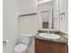 Cozy half bathroom features a vanity with a sink and a toilet for guests at 8547 S Tibbs Ave, Indianapolis, IN 46217