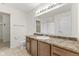 Bright bathroom with a large mirror, vanity with brown cabinets and a tile floor at 8547 S Tibbs Ave, Indianapolis, IN 46217
