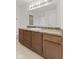 Clean bathroom featuring vanity with a decorative countertop, sink, and large mirror with vanity lighting at 8547 S Tibbs Ave, Indianapolis, IN 46217