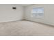 Spacious carpeted bedroom featuring a large window offering ample natural light at 8547 S Tibbs Ave, Indianapolis, IN 46217
