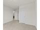 Well-lit bedroom with neutral carpeting and direct bathroom access at 8547 S Tibbs Ave, Indianapolis, IN 46217