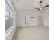 Large bedroom featuring neutral carpet, ceiling fan, and a view leading to a bathroom and additional rooms at 8547 S Tibbs Ave, Indianapolis, IN 46217