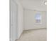 Comfortable bedroom with neutral carpet and a window for natural light at 8547 S Tibbs Ave, Indianapolis, IN 46217