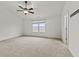 Spacious bedroom with a ceiling fan and large sun-filled window at 8547 S Tibbs Ave, Indianapolis, IN 46217