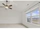 Spacious bedroom with a ceiling fan and large window, offering plenty of natural light and scenic views at 8547 S Tibbs Ave, Indianapolis, IN 46217