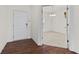 Welcoming entryway with hardwood floors leading to a bright room with neutral carpeting at 8547 S Tibbs Ave, Indianapolis, IN 46217
