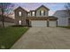 Inviting two-story home with brick and siding, a well-manicured lawn, and a convenient two-car garage at 8547 S Tibbs Ave, Indianapolis, IN 46217