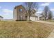 Charming two-story home featuring brick accents, a two-car garage, and a spacious front yard at 8547 S Tibbs Ave, Indianapolis, IN 46217