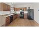 Well-equipped kitchen with wood cabinets, black appliances, and plenty of counter space at 8547 S Tibbs Ave, Indianapolis, IN 46217