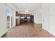 Charming eat-in kitchen featuring wood floors, cabinets, and modern black appliances at 8547 S Tibbs Ave, Indianapolis, IN 46217