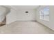 Bright, spacious living room with neutral carpet and ample natural light from the large window at 8547 S Tibbs Ave, Indianapolis, IN 46217