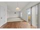 Open-concept living space with wood-look floors leading to a carpeted living room and slider doors at 8547 S Tibbs Ave, Indianapolis, IN 46217