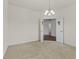Bright, carpeted room with a modern chandelier and doors leading to the bathroom and entryway at 8547 S Tibbs Ave, Indianapolis, IN 46217