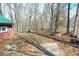 A view of the backyard with a garage or shed and a firepit at 9464 N State Rd 135, Morgantown, IN 46160
