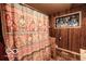 Bathroom with a patterned shower curtain, tiled floor, wood paneling, and a stained glass window at 9464 N State Rd 135, Morgantown, IN 46160